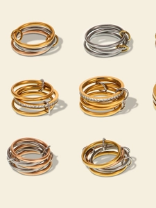 Macro detail of stacked multi-tone linked rings with gold finish and pavé cubic zirconia