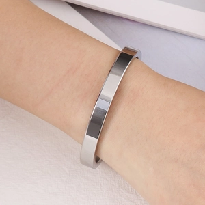 Minimalist silver stainless steel bangle bracelet with a high-polished mirror finish