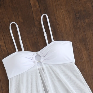 Detailed view of white bikini top with sheer mesh texture and silver metal ring detail