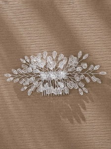 Detailed close-up of handmade bridal hair comb with silver wire, crystals and pearls
