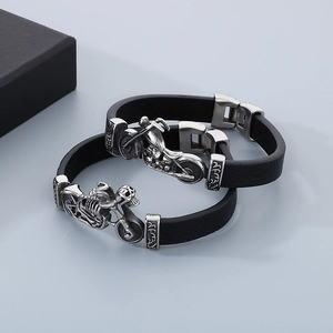 Macro detail of stainless steel clasp on black woven leather motorcycle skull bracelets