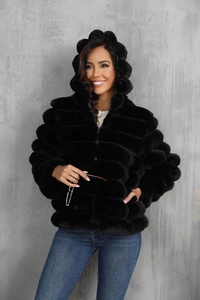 Detail of black faux fur hoodie featuring 3D bubble texture and a full zip closure