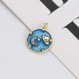Detail of blue enamel celestial pendant with gold crescent moon and sparkling stars