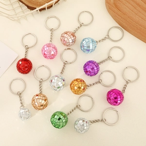 Detailed view of colorful disco ball keychains in gold, silver, pink, and blue finishes