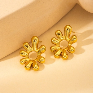 Detailed shot of golden irregular melted flower stud earrings on geometric stands