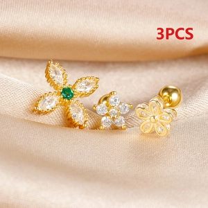 Macro shot of 3pcs gold stainless steel stud earrings with zircon stars and flowers