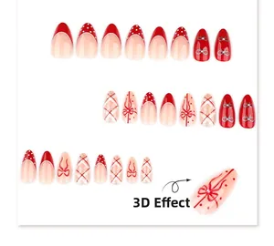 Detailed view of red and white almond press-on nails with 3D bows and polka dot patterns
