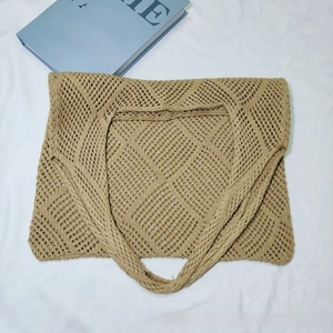 Macro detail of khaki crochet tote bag featuring intricate hollow diamond knit pattern