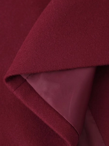 Macro detail of deep red wool fabric texture with smooth inner lining of the coat