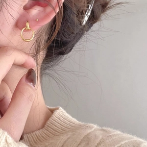 Minimalist S925 sterling silver geometric hoop earrings worn on ear by a model