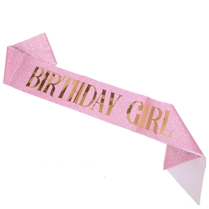 Detail of pink glitter Birthday Girl sash with shimmering gold foil lettering