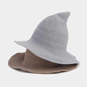 Detail of light grey and khaki knitted wizard hats with pointed tops and wavy brims