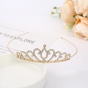 Close-up of golden bridal tiara with sparkling crystal rhinestones on elegant ceramic base