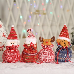 Detailed view of four 3D knitted Christmas drawstring gift bags with cartoon characters