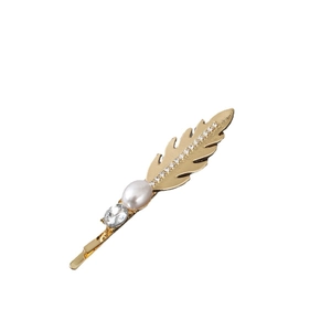 Elegant gold feather hair clip with pearl and sparkling rhinestones on white backdrop