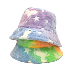 Detail of plush tie-dye bucket hats showing gradient star patterns and fluffy texture