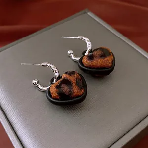 Retro heart leopard print earrings with matte black borders and textured silver hooks