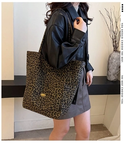 Detail of large leopard print tote bag showing texture and size on a shoulder