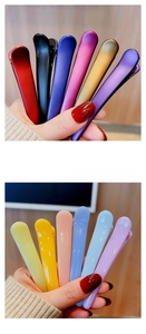 Close-up of 12 assorted matte and glossy hair clips in various vibrant candy colors