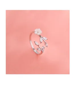 Detailed close-up of S925 sterling silver flower ring with zircon leaf details on pink base