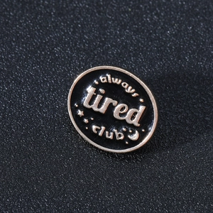 Funny Always Tired Club enamel brooch pin with stars and moon on black leather background