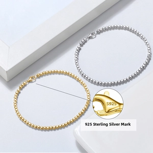 Close-up of S925 hallmark on round bead sterling silver bracelet with gold and silver finish