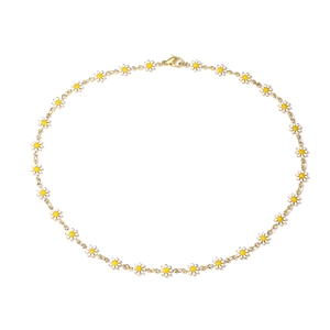 Detailed close-up of a gold daisy necklace with white enamel petals and lobster clasp