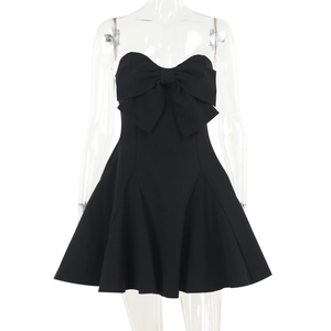 Detail of black strapless mini dress featuring a large bow and a structured A-line silhouette