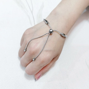 Close-up of adjustable stainless steel snake chain bracelet with bolo sliding clasp on wrist