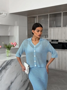 Detailed knit texture of light blue crochet cardigan and matching skirt with white buttons