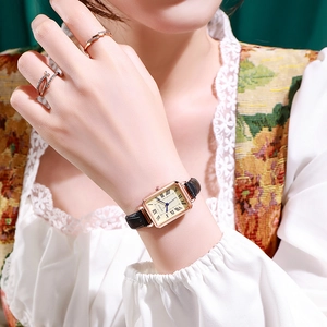 Detail of elegant square vintage quartz watch with Roman numerals and black leather strap