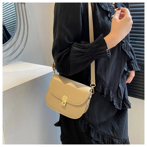 Beige PU leather saddle bag with flap closure shown on model for daily casual outfit style