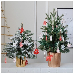 Close-up of festive wooden reindeer and snowflake ornaments on a mini Christmas tree