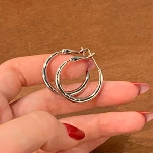Minimalist silver hoop earrings for women with a smooth polished metallic finish