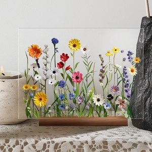 Close-up of dried flowers preserved in transparent acrylic frame with wooden base stand