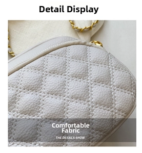 Close-up of beige quilted leather handbag with lychee texture and gold chain strap