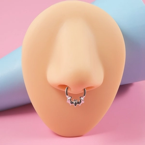 Detailed view of a silver bat septum ring displayed on a realistic nose model