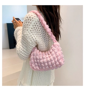 Detail of light pink cloud puff shoulder bag with textured ruched fabric material