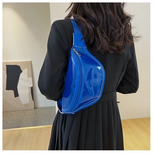 Close-up of a glossy bright blue PVC chest bag with contrast white stitching details