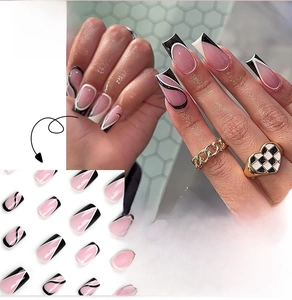 Detail of long coffin press-on nails with black and white abstract swirling line patterns