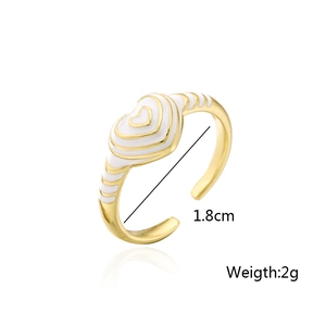 Detailed view of 18K gold plated heart ring with white enamel and size measurements