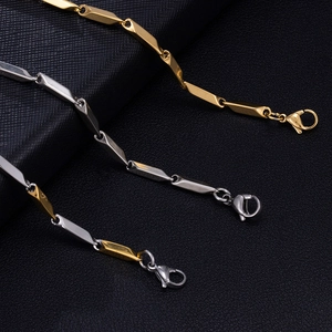 Detailed view of 18k gold and silver melon seed chain necklaces with lobster clasps