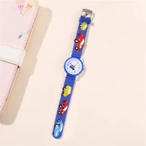 Close-up of blue silicone kids watch featuring 3D cartoon car patterns and easy-read dial
