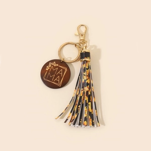Leopard MAMA keychain with wooden tag, sunflower tassel and gold hardware on beige base