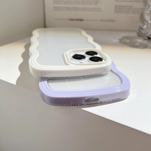 Detail of wavy frame phone cases in white and light purple with transparent backplate