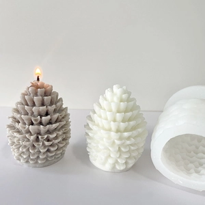 3D pinecone candle silicone mold with finished wax candles in grey and white