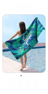 Detail of outdoor quick-dry beach towel with tropical leaves and Hello Summer print