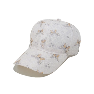 Detail of white lace baseball cap featuring colorful butterfly and star embroidery patterns