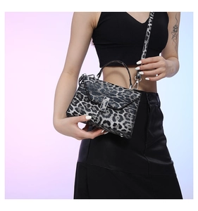Fashionable leopard print handbag with silver buckle and adjustable shoulder strap