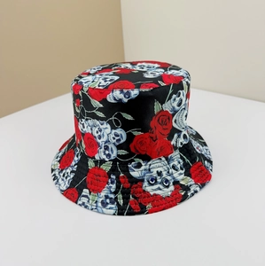 Detail of bucket hat with vibrant red roses and skull print on black fabric